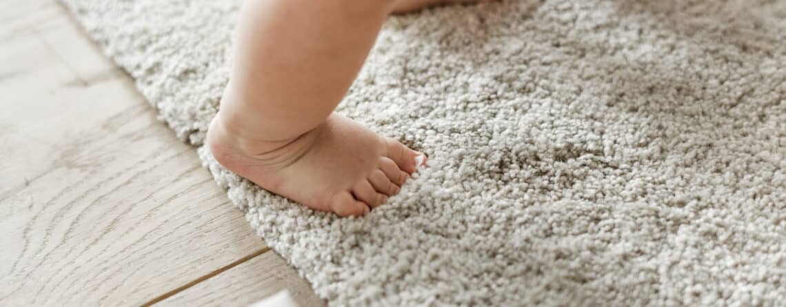 closeup of baby's legs while standing