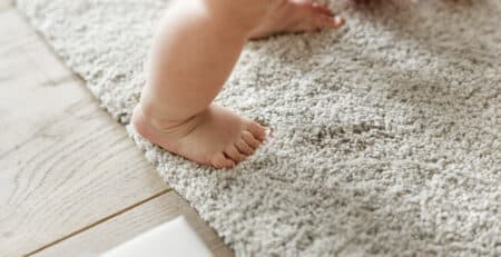 closeup of baby's legs while standing