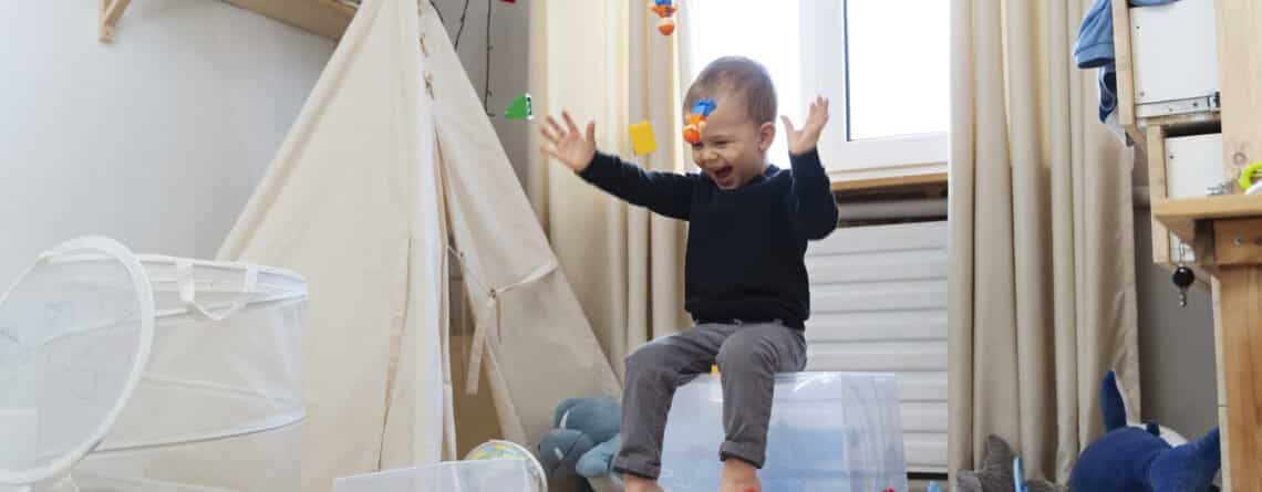 full shot happy kid sitting container (1)