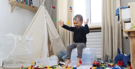 full shot happy kid sitting container (1)